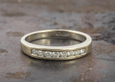 Lot 46 - An 18ct continental diamond half hoop eternity ring