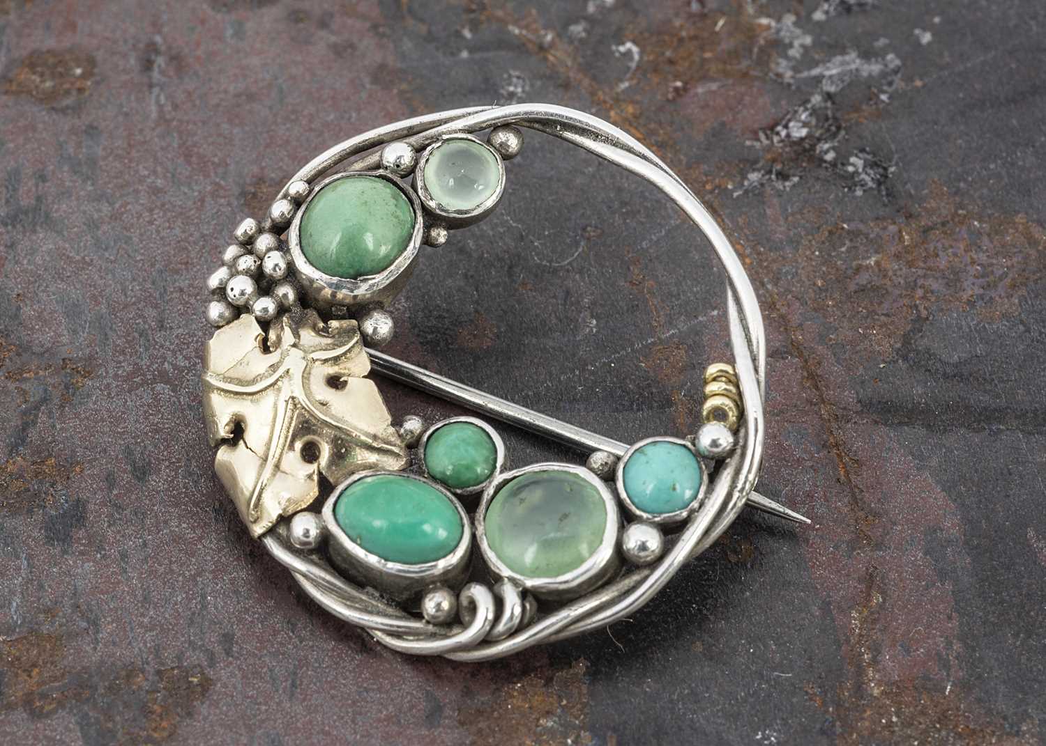 Lot 65 - An Arts and Crafts Sybil Dunlop style circular brooch