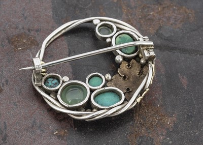 Lot 65 - An Arts and Crafts Sybil Dunlop style circular brooch