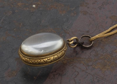 Lot 116 - A late 19th Century oval rock crystal and yellow metal locket