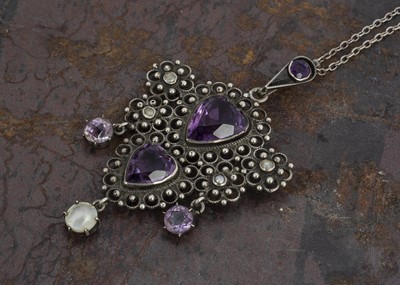Lot 129 - An Art and Crafts amethyst and seed pearl heart shaped pendant in the style of George Gaskin