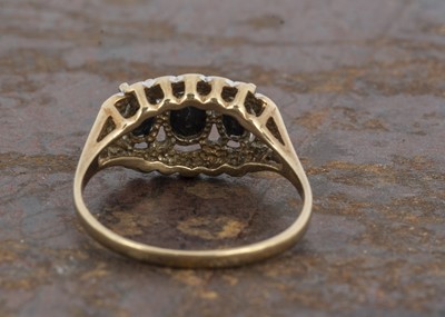 Lot 136 - A three stone sapphire and diamond dress ring
