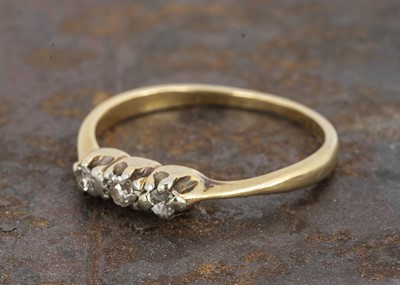 Lot 140 - An 18ct gold 'Forget-me-not' three stone diamond dress ring