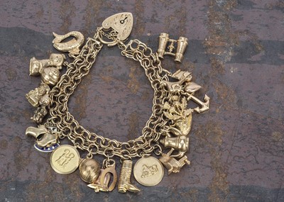 Lot 161 - A 9ct gold double curb link and heart decorated charm bracelet