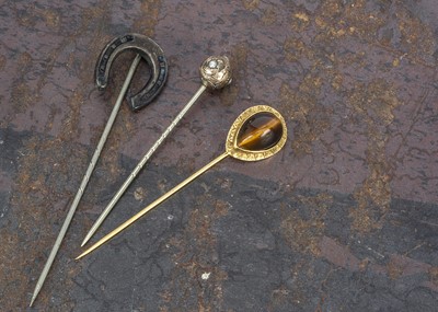 Lot 165 - A yellow metal tiger's eye mounted stick pin