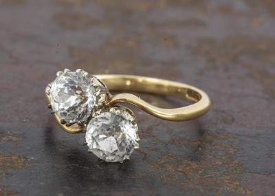 Lot 199 - An 18ct gold zircon crossover dress ring