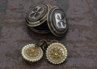 Lot 216 - Three 19th century mother of pearl buttons and a mother of pearl clock fastener (5)