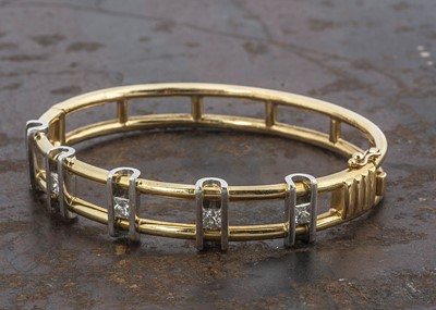 Lot 231 - An 18ct gold and platinum diamond set bangle