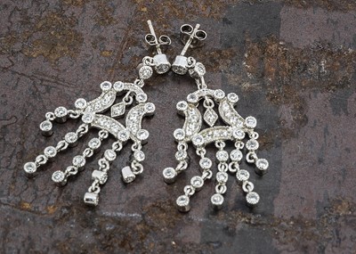 Lot 238 - A pair of cz and silver chandelier drop earrings