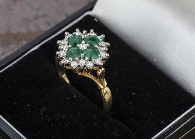 Lot 244 - An 18ct gold emerald and diamond cluster ring