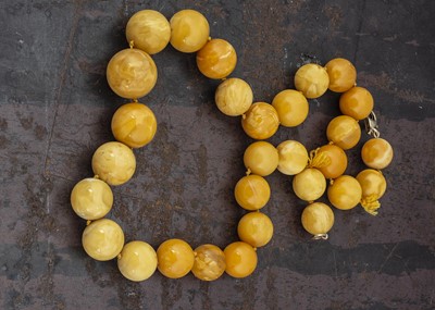 Lot 270 - A string of amber spherical graduated beads