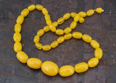 Lot 281 - A string of amber oval beads