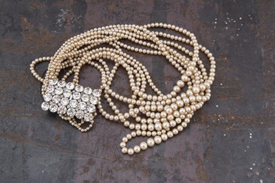 Lot 293 - A paste and simulated multi strand necklace