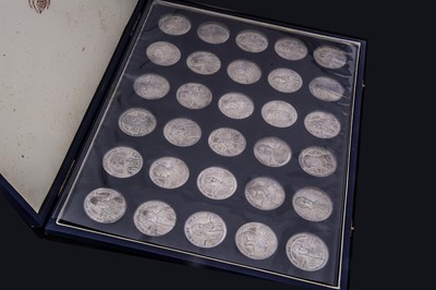 Lot 333 - A boxed set of thirty silver medallions