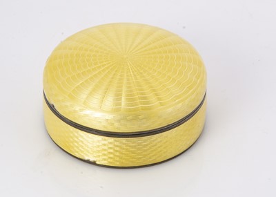 Lot 527 - An Art Deco period silver and yellow enamel circular box