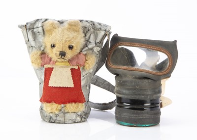 Lot 241 - A Farnell WW2 child's gas mask in a teddy bear carry case