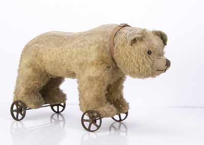 Lot 324 - A 1920s British teddy bear on wheels