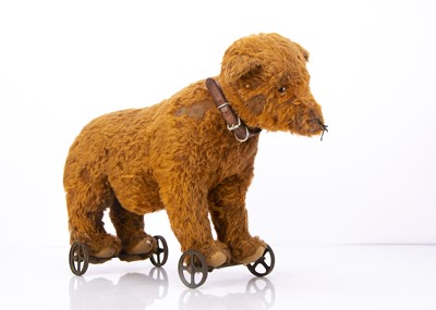 Lot 334 - An early Steiff cinnamon mohair bear on wheels circa 1906-08