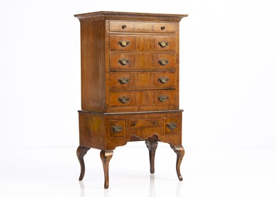Lot 678 - A 20th century walnut chest of drawers on stand