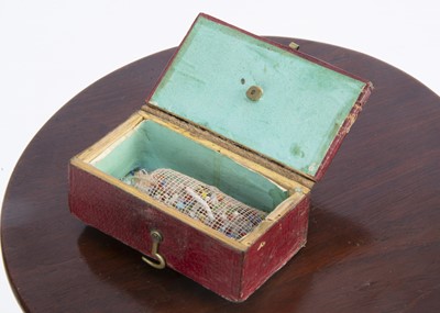 Lot 689 - An early 19th century small red leather box surmounted with a gilt metal cherub