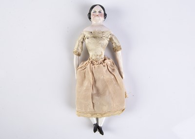 Lot 821 - A 19th century pink-tinted china shoulder head dolls’ house doll