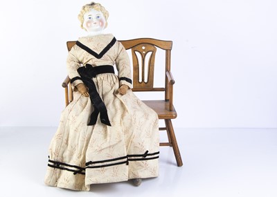 Lot 1024 - A 19th century German china shoulder head doll