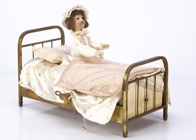 Lot 1030 - A French musical automation of a girl in brass bed 1910-20s