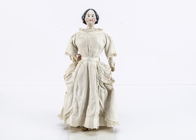 Lot 1115 - A German mid 19th century china shoulder-head doll with elaborate hair