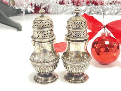 Lot 12 - A pair of George V period silver sugar sifters by S.B.S Ltd