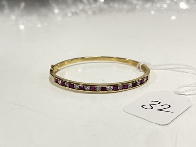 Lot 32 - A modern and very pretty 18ct gold bangle set with diamonds and rubies