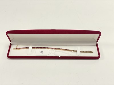 Lot 33 - A modern and pretty gold and ruby tennis bracelet
