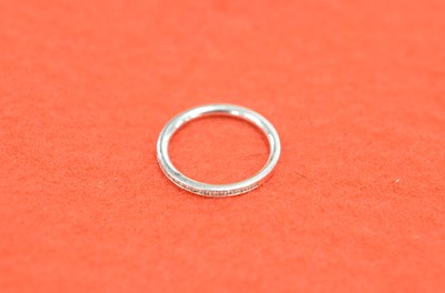 Lot 59 - A modern 18ct gold and diamond half hoop eternity ring