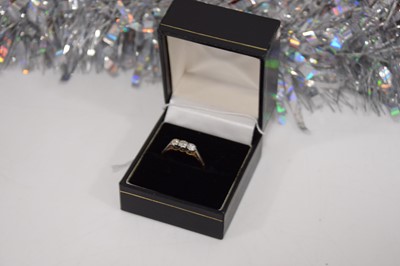 Lot 105 - A diamond three stone dress ring