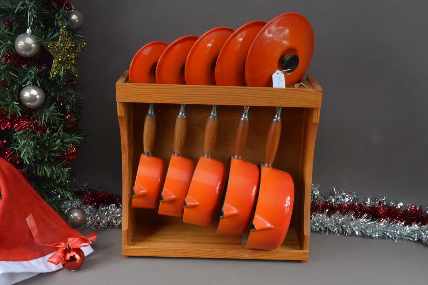 Lot 139 - A set of Le Cresuset graduated cast iron cooking pans and pine fitted rack hanging rack