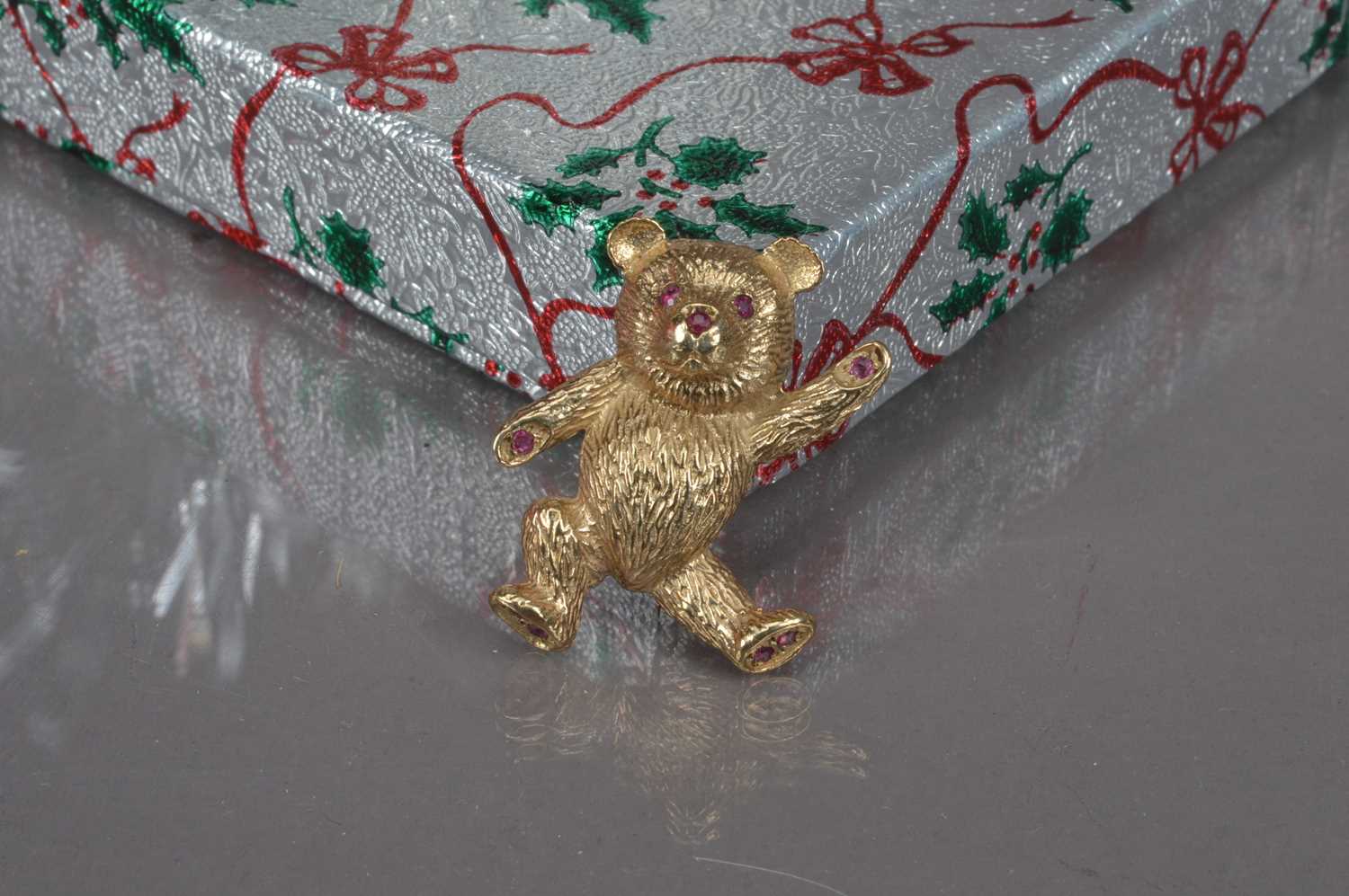 Lot 180 - A cute modern 9ct gold and ruby set Teddy Bear brooch