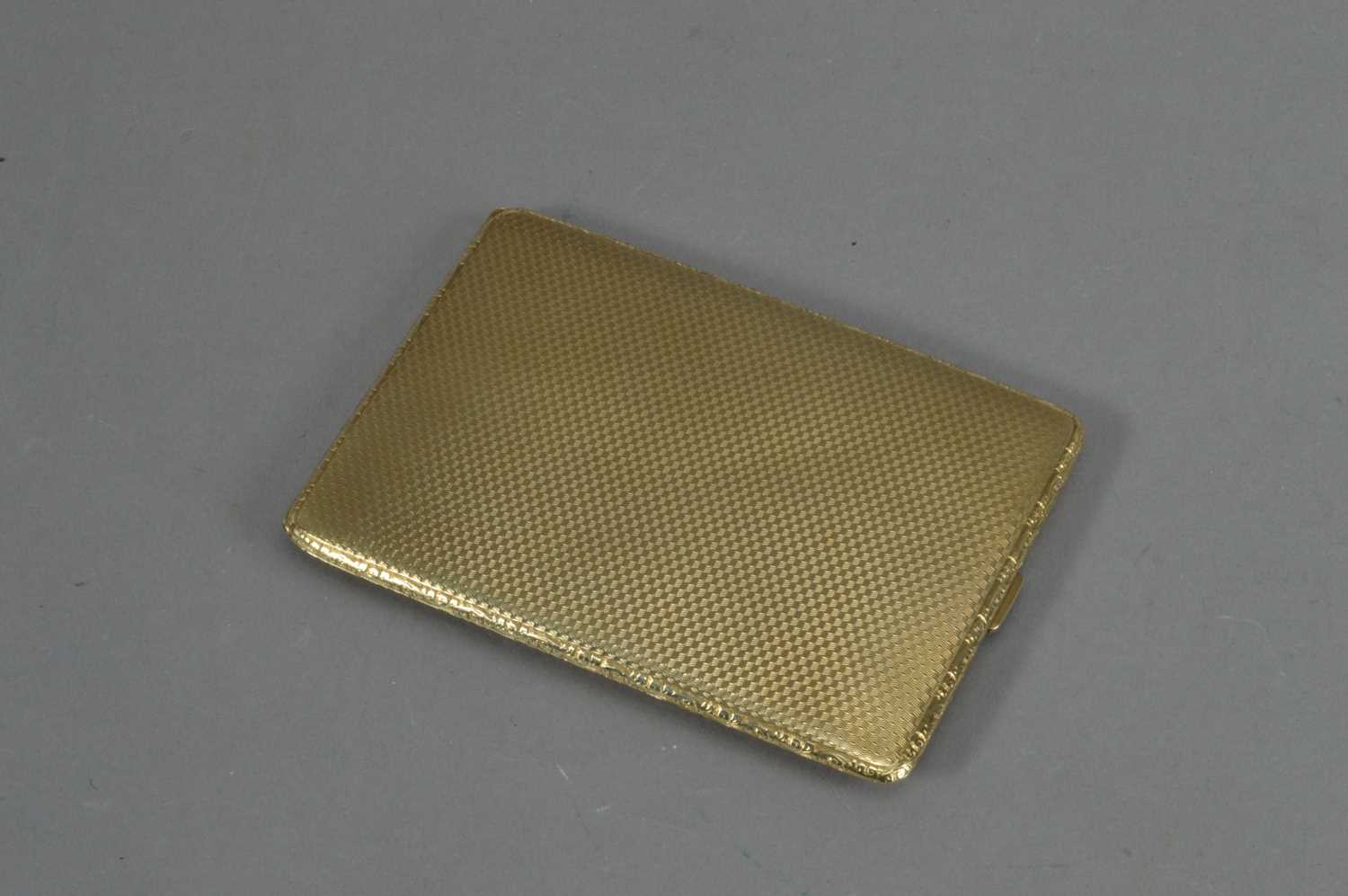 Lot 110 - A George V art deco 9ct. gold sprung hinged cigarette case