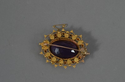 Lot 113 - An Edwardian 9ct marked yellow metal amethyst and seed pearl oval brooch