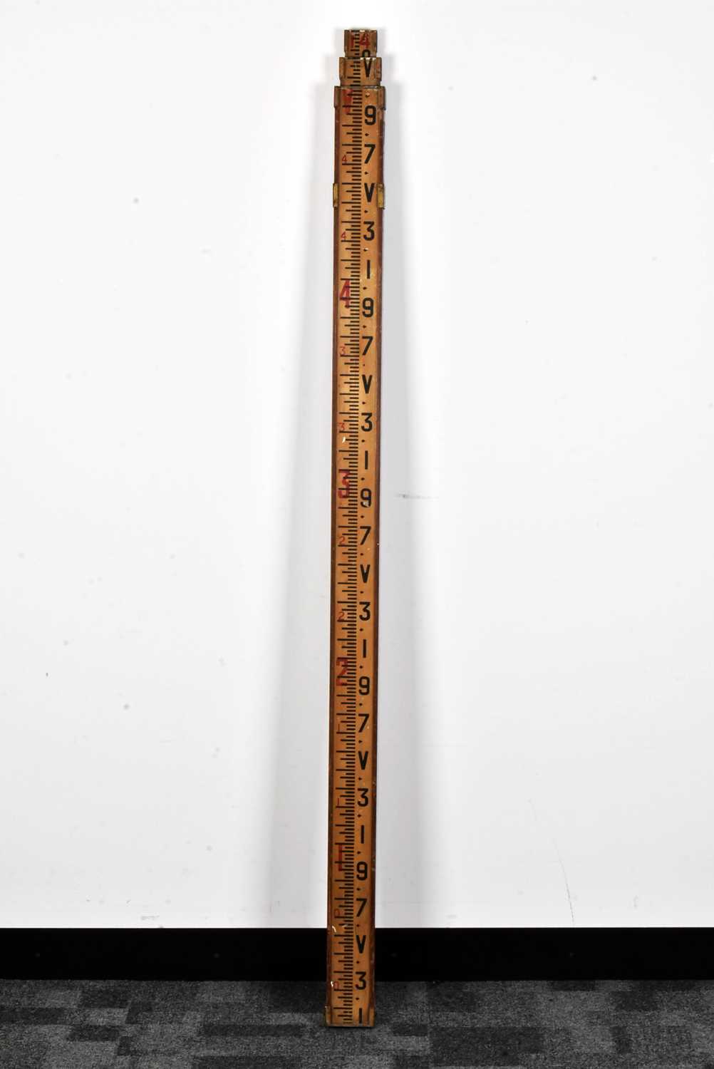 Lot 130 - An extendable measuring stick,
