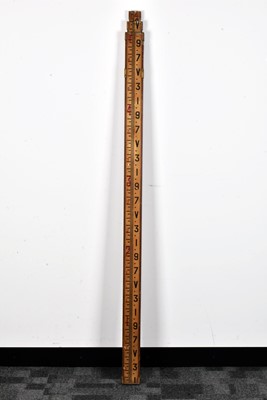 Lot 130 - An extendable measuring stick