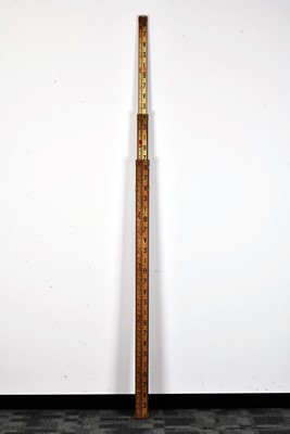 Lot 130 - An extendable measuring stick