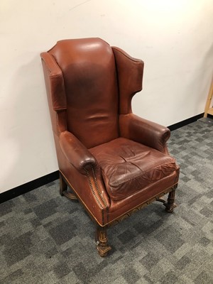 Lot 15 - An early 20th century leather wingback armchair
