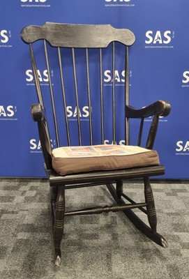 Lot 109 - A 20th century ebonised rocking chair