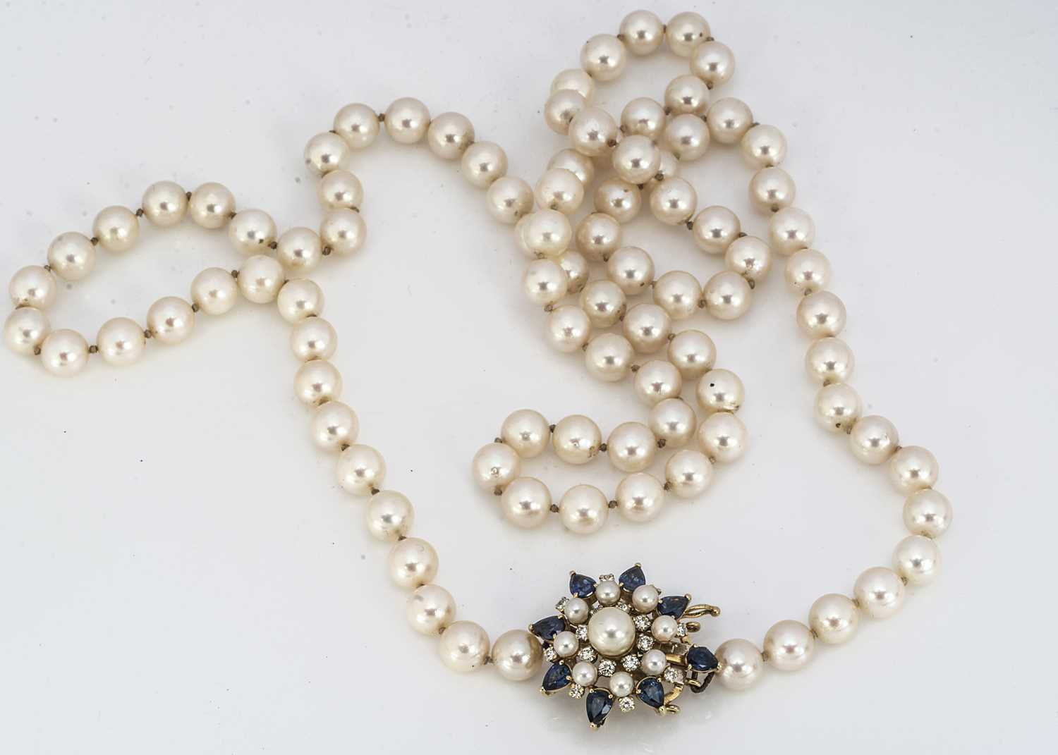 Lot 203 - An opera length uniform cultured knotted pearl necklace