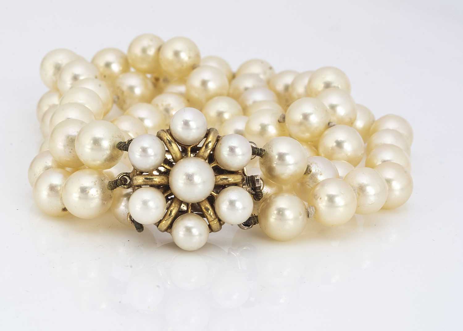 Lot 209 - A cultured pearl three strand cultured pearl