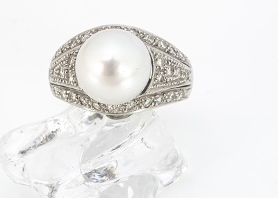 Lot 219 - A contemporary 18ct white gold diamond and cultured pearl dress ring