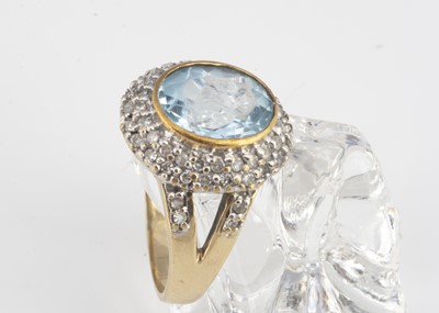 Lot 21 - A topaz and diamond 9ct gold cluster dress ring