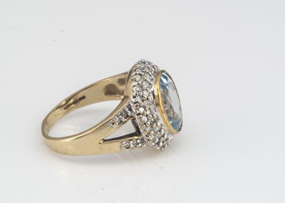 Lot 21 - A topaz and diamond 9ct gold cluster dress ring