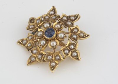 Lot 26 - A yellow metal seed pearl and sapphire flower brooch