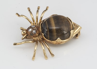Lot 115 - A continental yellow metal tiger's eye and diamond 18ct marked spider brooch