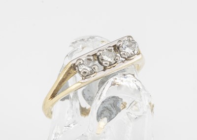 Lot 144 - An 18ct gold three stone diamond dress ring